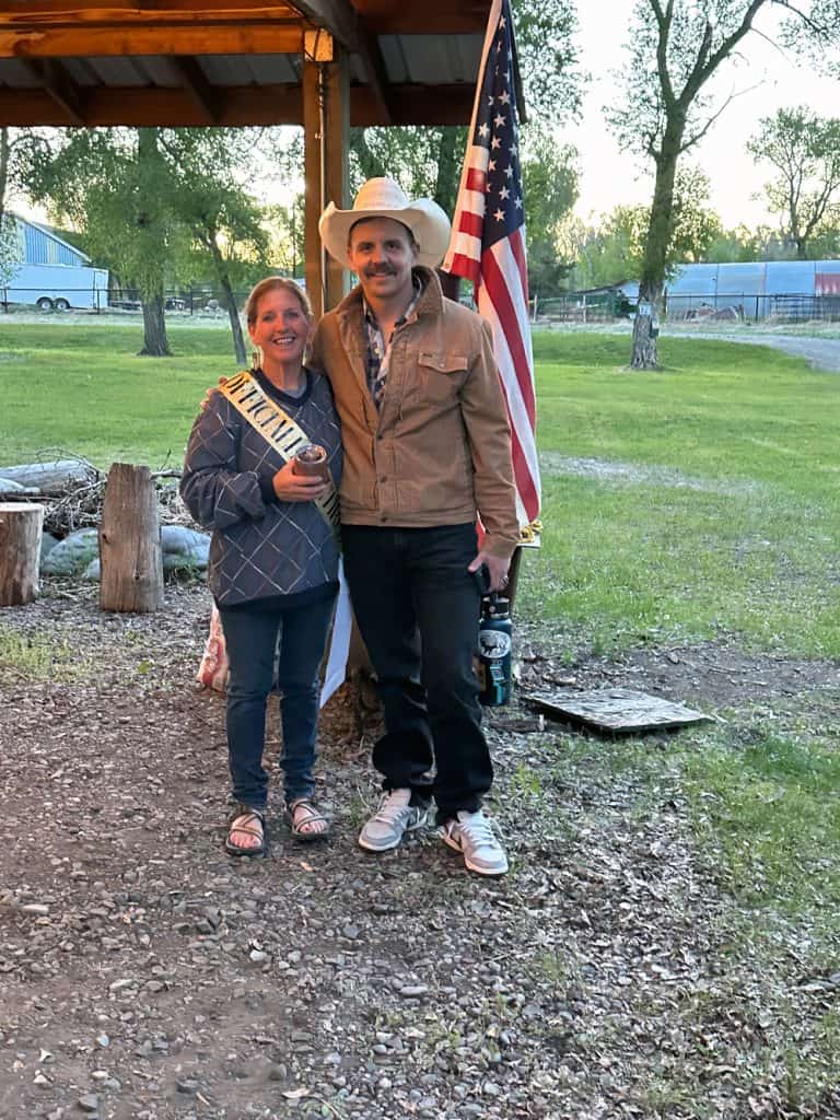 Smiling couple with cowboy hat at Oasis Motel & RV Park in Meeteetse, Wyoming.