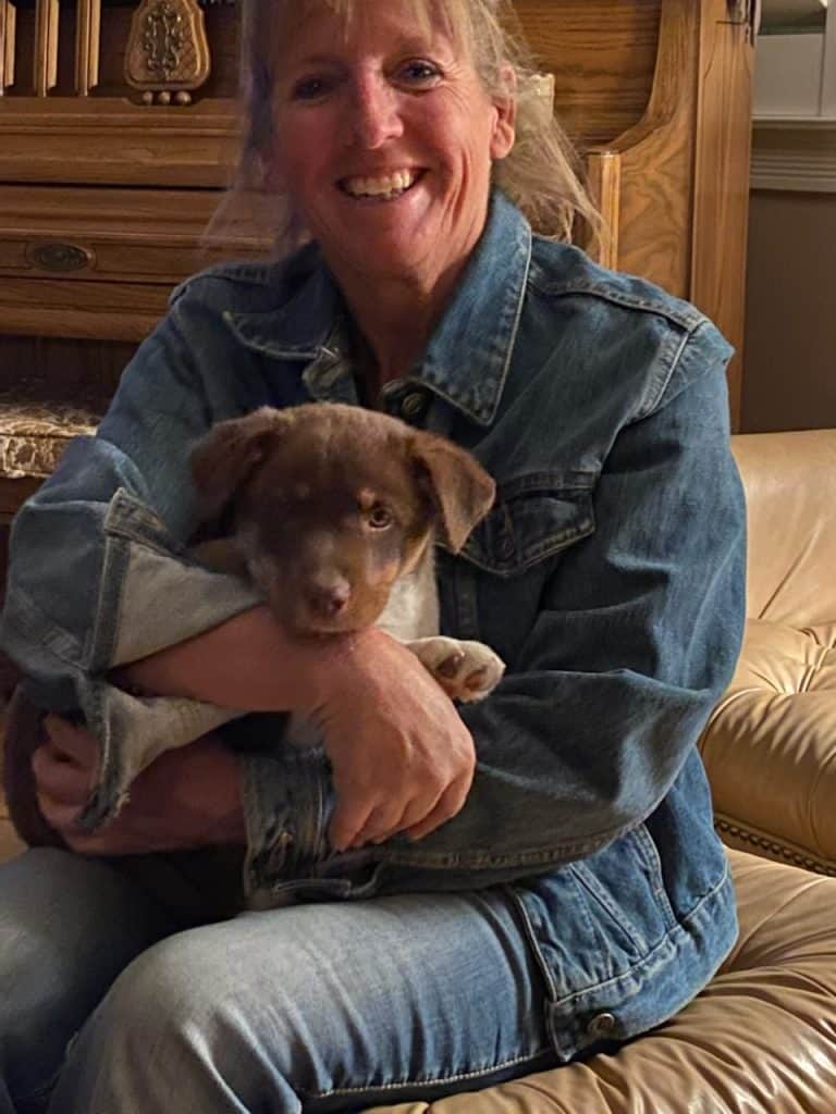 Jersey Denvir, Owner of Oasis Motel & RV Park, Meeteetsee, WY - pictured with her puppy