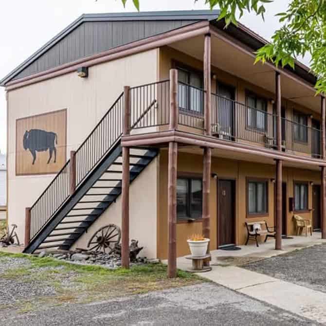 Two-story motel building with outdoor stairs and balcony in Wyoming.